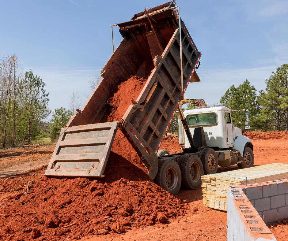 Loaded Frigx tipper truck, three-quarter front view, number plate readable, driver by the cab